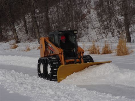 track skid steer pushing snow|over tire skid steer tracks.